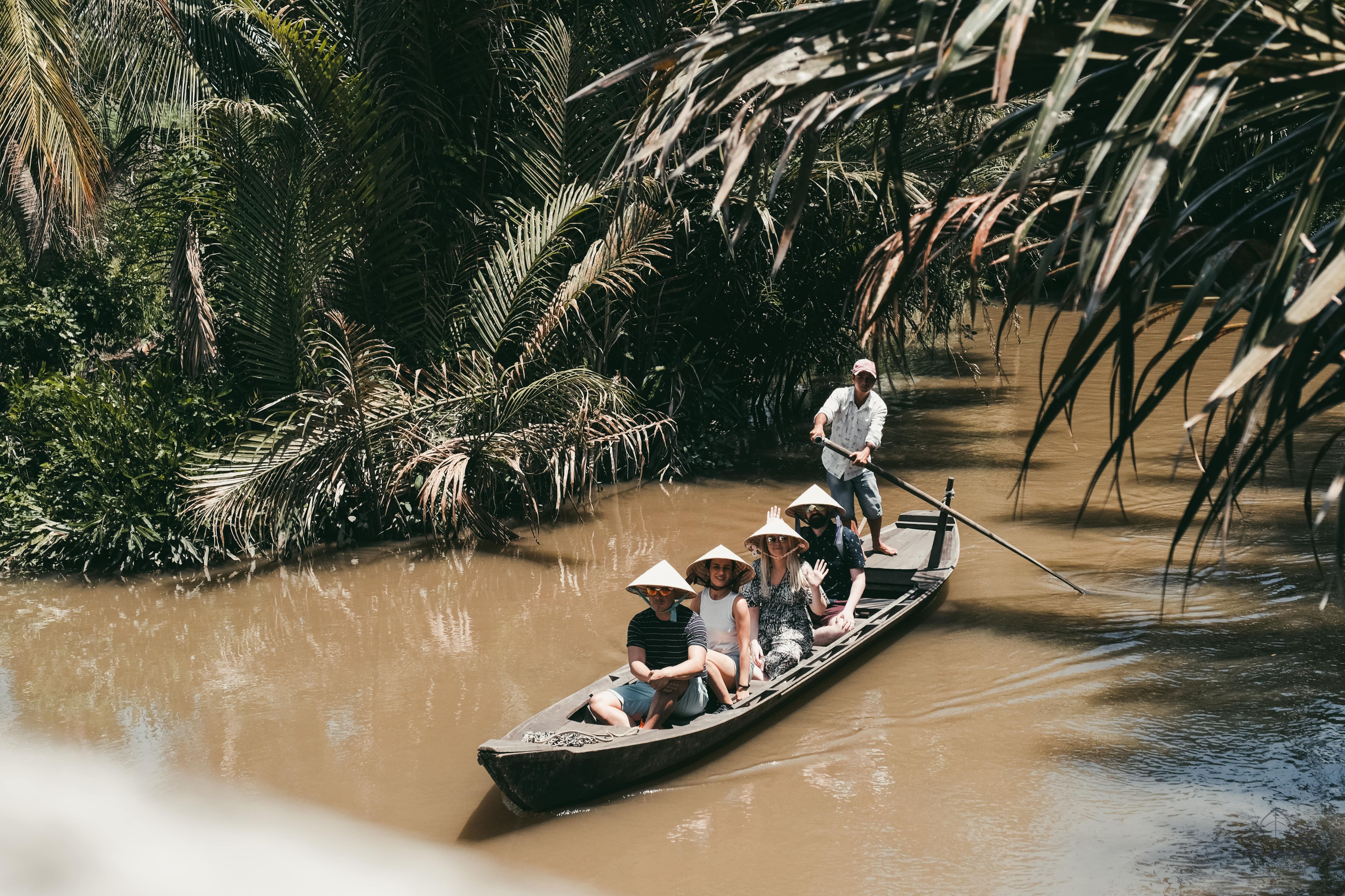  Tourists cruising along the Mekong River on a wooden boat.